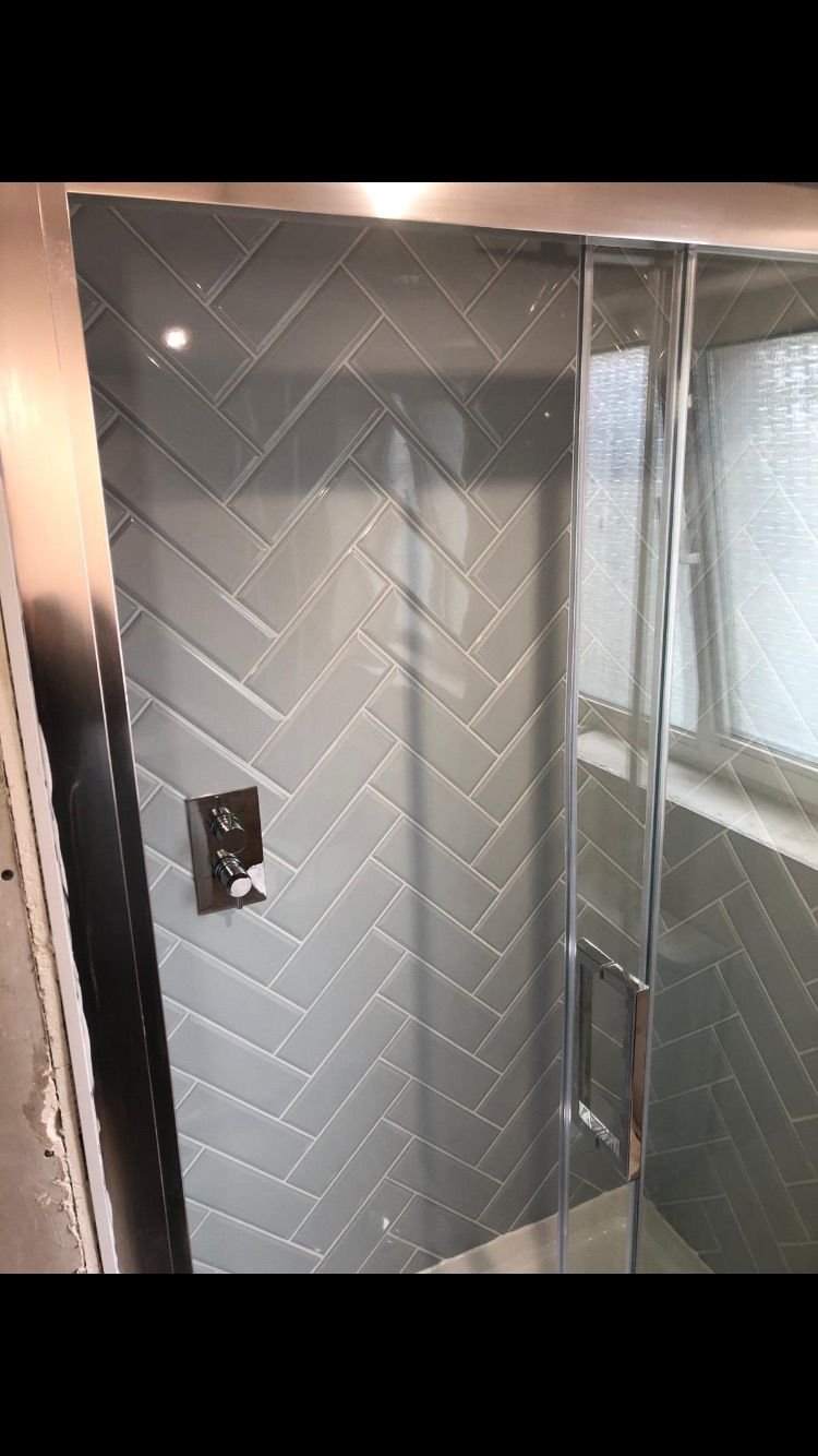 A herringbone tiled shower enclosure