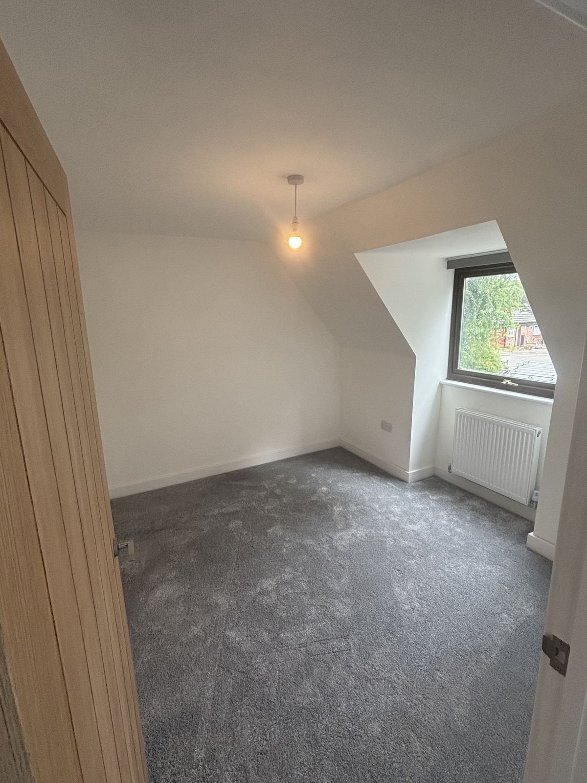 A loft bedroom with a dormer window