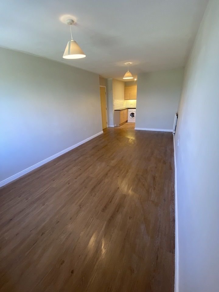 An open-plan room with new LVT flooring