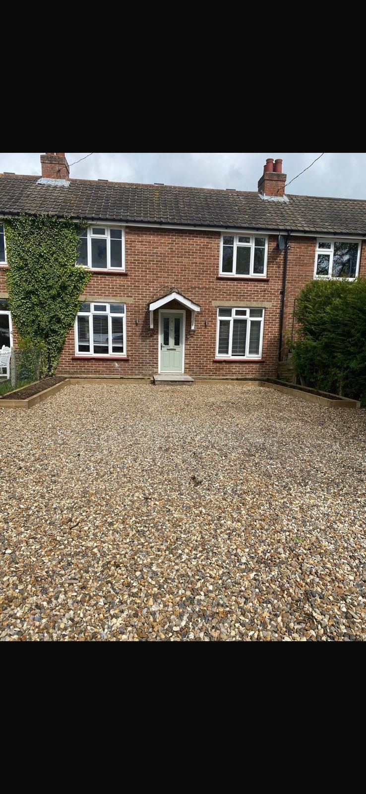 A brick terrace with a new gravel driveway