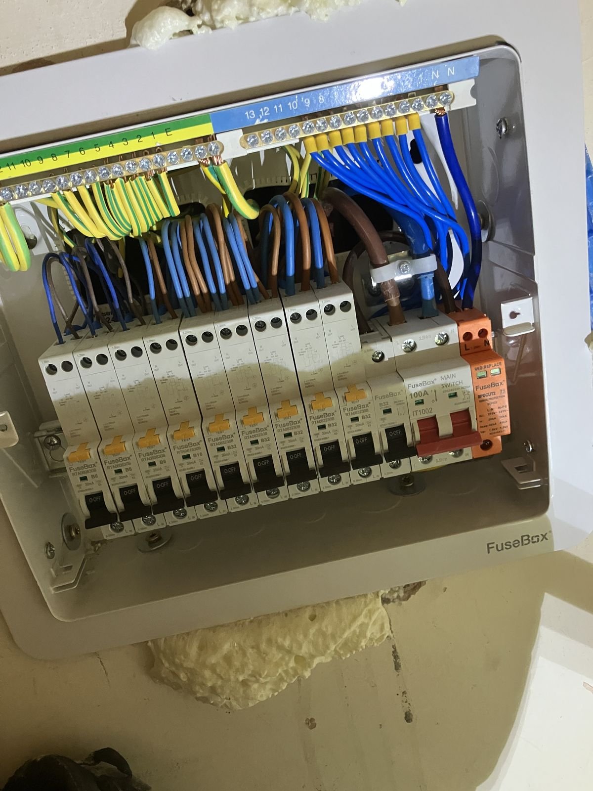 A consumer unit with neatly run cabling, cover off