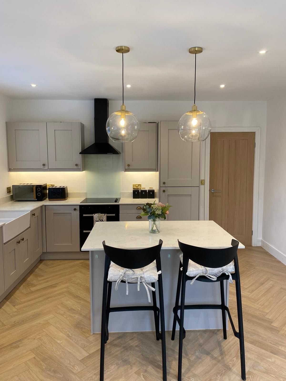 A shaker kitchen with a black extractor